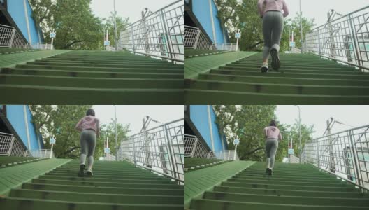 亚洲女人在楼梯上跑上跑下。人们早上慢跑锻炼高清在线视频素材下载