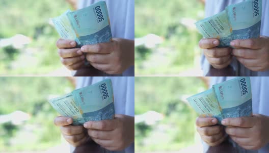 数印尼盾钞票的概念高清在线视频素材下载