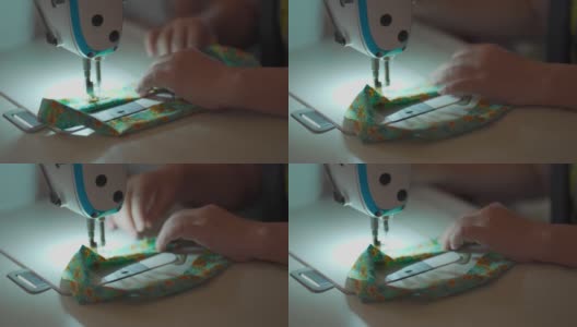 特写亚洲华人女裁缝的手工缝纫过程，在缝纫机上缝纫。高清在线视频素材下载