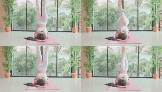 4K慢动作:年轻的亚洲女性在家练瑜伽，追求健康的生活方式。高清在线视频素材下载