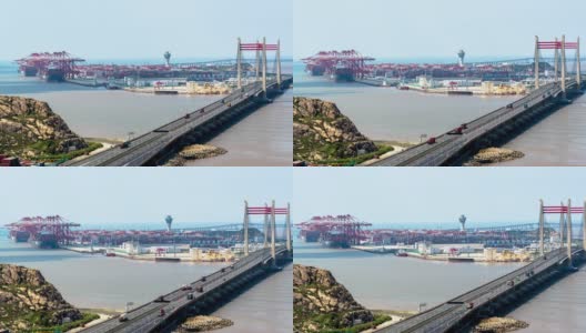 4K时间推移:鸟瞰图的自动化工业港与货船和集装箱卡车在桥上。高清在线视频素材下载