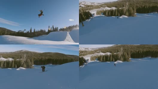 慢动作，无人机拍摄的滑雪者在完整的冬季装备完成一个跳跃与森林和滑雪升降机在背景在埃尔多拉滑雪度假村附近博尔德，科罗拉多州在一个明亮，阳光明媚的日子高清在线视频素材下载