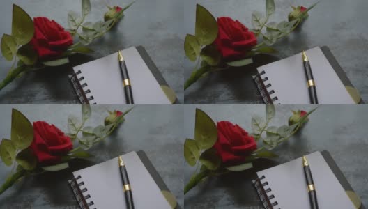 空白页笔记本，钢笔和美丽的红玫瑰在乡村金属地板背景与复制空间。情书写作建议或提议概念为情人节婚礼和假期。前视图。高清在线视频素材下载