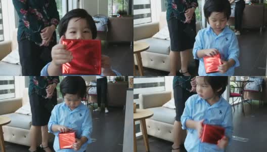 亚洲男孩有乐趣打开礼物高清在线视频素材下载