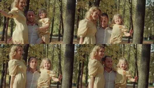 快乐的一家人在秋天的公园里合影高清在线视频素材下载