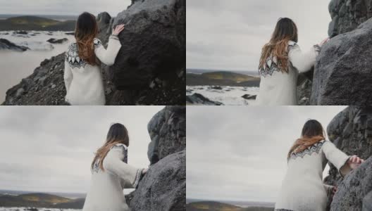 年轻的探险家女人走过岩石在山上的后视图，靠近Vatnajokull冰泻湖在冰岛高清在线视频素材下载