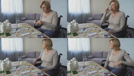 患抑郁症的女士在轮椅上服用止痛药受伤治疗高清在线视频素材下载
