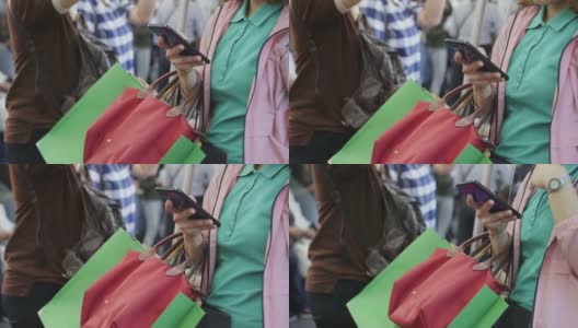 年轻女子在乘坐地铁时使用智能手机，慢镜头高清在线视频素材下载