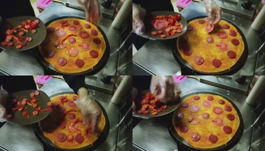 厨师把一些意大利腊肠放在薄饼上，放在黑色的炊具上高清在线视频素材下载