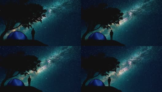 那男人和女人站在树旁，映衬着星空。时间流逝高清在线视频素材下载