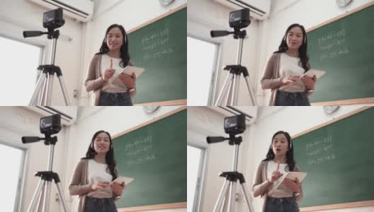亚洲女教师在隔离期间在教室进行在线教学和演讲高清在线视频素材下载