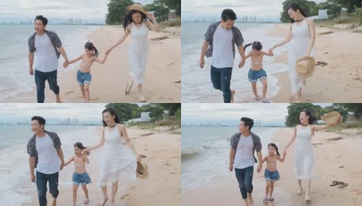 亚洲家庭与孩子在海滩散步快乐度假的概念高清在线视频素材下载