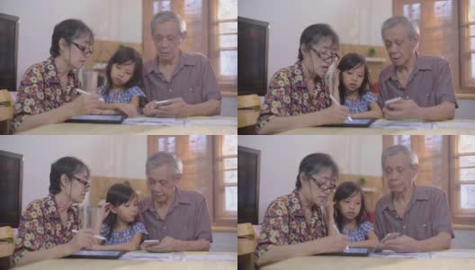 亚洲老人和高级妇女和女孩做他们的预算和财务在家里高清在线视频素材下载