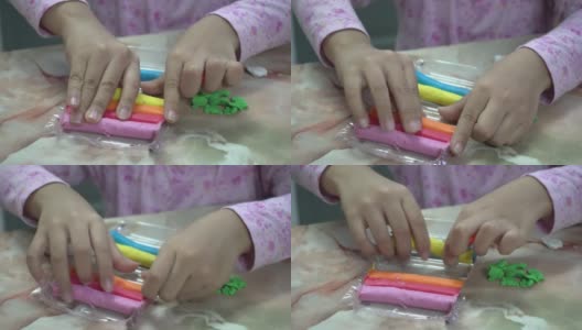 一个女孩拿出五颜六色的黏土高清在线视频素材下载