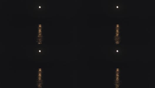 月亮在夜晚的河流或海洋的路径。月光映在水面上。黑色背景高清在线视频素材下载
