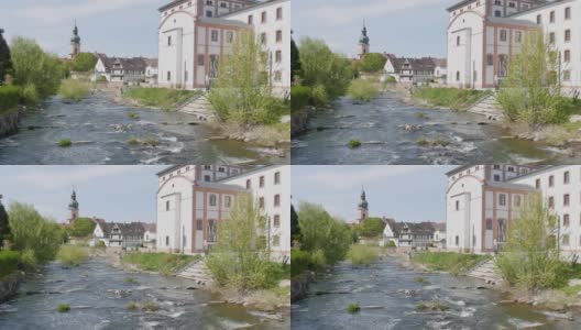 在风景如画的德国教堂中，可以看到山的堤岸、湍急的小溪和威尔斯特村高清在线视频素材下载