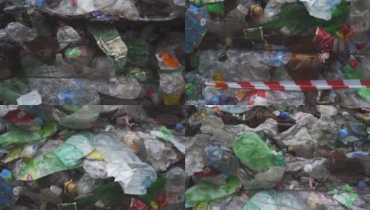 在废物回收厂为垃圾回收准备的一捆压过的塑料瓶。镜头从下到上移动。污染问题。稳定的视频高清在线视频素材下载