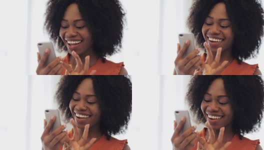 快乐的非裔美国女人拿着智能手机高清在线视频素材下载