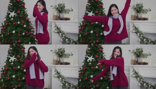 年轻的亚洲妇女在毛衣享受跳舞和庆祝圣诞派对在家里，冬季假期和圣诞节的概念高清在线视频素材下载