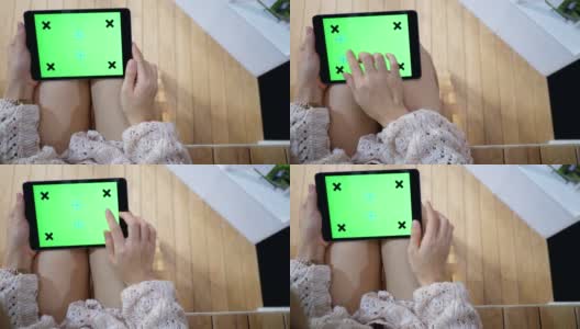 女人在用绿色屏幕的平板电脑高清在线视频素材下载