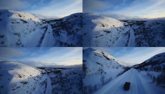 冬季驾驶-冬季道路的乡村道路，通过一个冬季的山区景观高清在线视频素材下载
