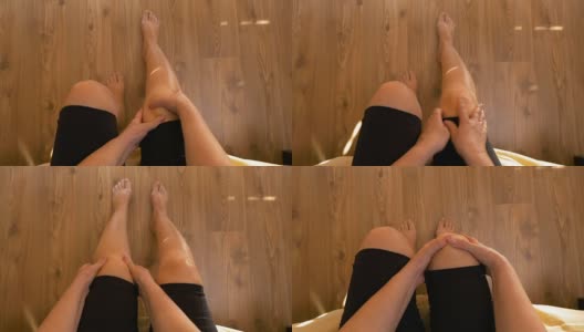 女人坐在床上按摩双膝关节疼痛的观点高清在线视频素材下载
