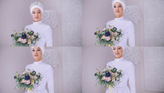 美丽的模特白色穆斯林婚纱和新娘头饰与鲜花高清在线视频素材下载