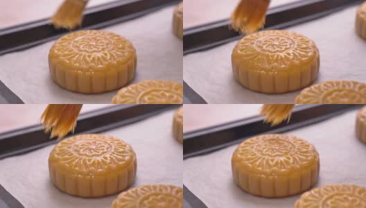中秋节月饼的制作工艺——妇女在烘烤前刷蛋液在面点表面。节日的概念。高清在线视频素材下载