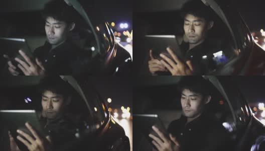 一个自由职业者晚上在车里用平板电脑工作高清在线视频素材下载