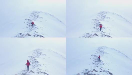 女性高山攀登者正在冬季攀登高海拔山脉的顶峰高清在线视频素材下载