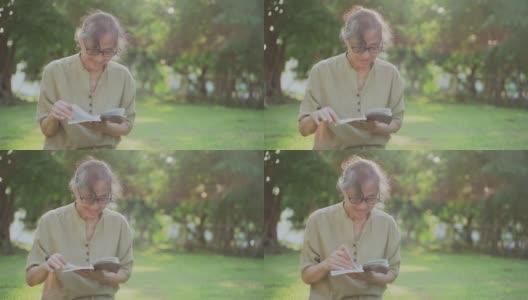 老年女性喜欢在户外读书高清在线视频素材下载