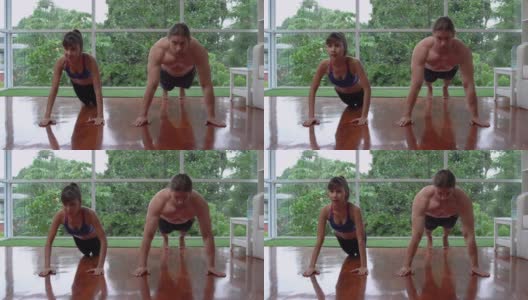 迷人的亚洲女孩做和英俊的白人男子锻炼推举运动在客厅在家里高清在线视频素材下载