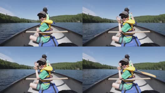在加拿大魁北克省的帕克国立毛里西(Parc National de la Mauricie)，一家人在瓦皮扎冈克(Wapizagonke)湖中划独木舟高清在线视频素材下载