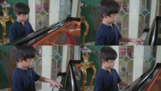 亚洲男孩在客厅里弹奏三角钢琴。孩子感到高兴和实践课。业余爱好和在家学习。快乐的一天和家庭的概念。活动和生活方式。高清在线视频素材下载