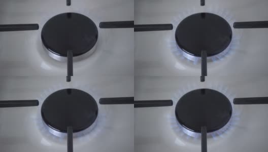 特写的一个黑色燃烧器的白色搪瓷煤气炉与蓝色的火。厨房用具用铸铁格栅。高质量的全高清镜头高清在线视频素材下载
