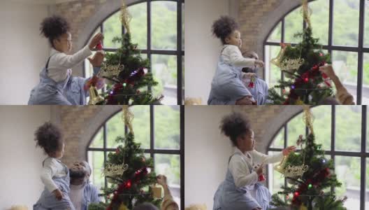 黑人家庭在装饰客厅的同时，一起庆祝圣诞节和新年高清在线视频素材下载