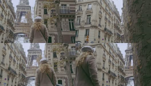 一个法国女人沿着街道走向艾菲尔铁塔高清在线视频素材下载