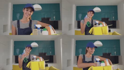 快乐的清洁女服务员拿着装有专用洗涤剂和清洁喷雾的盒子，站在菜馆里高清在线视频素材下载