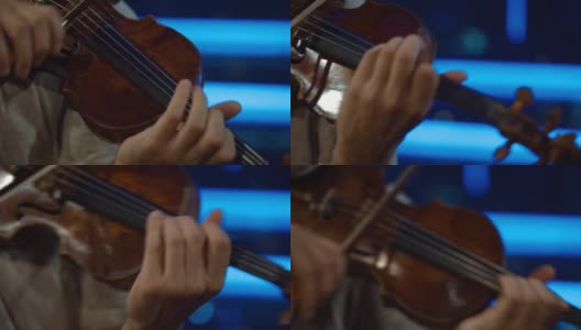 细节拍摄，小提琴手在舞台上的表演，亮，暗的背景高清在线视频素材下载