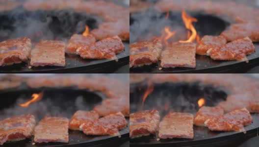 慢镜头:在火盆上用炽热的火焰烹煮肉排的过程-特写高清在线视频素材下载