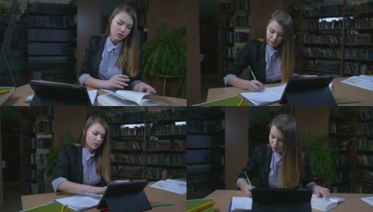 女孩在图书馆里用写字板准备考试高清在线视频素材下载