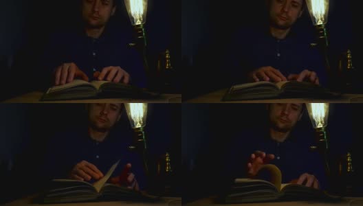 男人在晚上用老式灯看书。高清在线视频素材下载