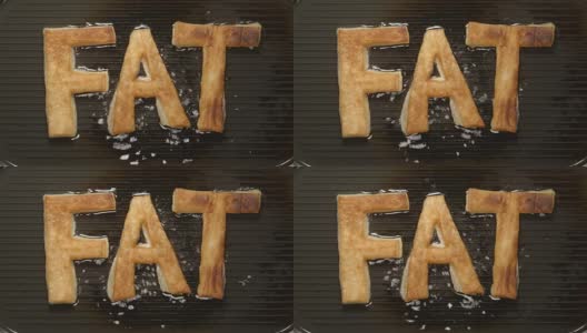 在烤架上用油煎胖字母(俯视图)高清在线视频素材下载