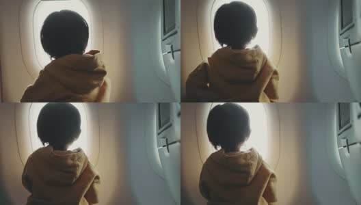 幼童正在通过窗户看全景飞机高清在线视频素材下载
