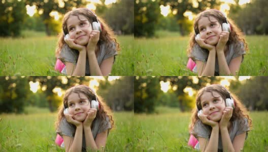 美丽的白人小女孩花时间在公共公园的肖像。学生小孩有很多乐趣放松户外和听音乐与耳机高清在线视频素材下载