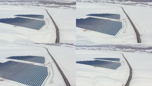 空中视角太阳能电池板农场绿色能源在冬季雪晴天高清在线视频素材下载