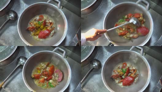 厨师在厨房里烹饪咖喱粉炒蟹，这是亚洲很受欢迎的海鲜菜单。炒蟹配咖喱粉、洋葱、青椒和鸡蛋。高清在线视频素材下载