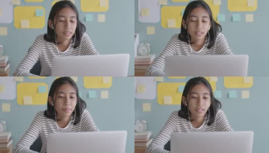 亚洲女孩在线学习与导师通过互联网上的笔记本电脑与耳机高清在线视频素材下载