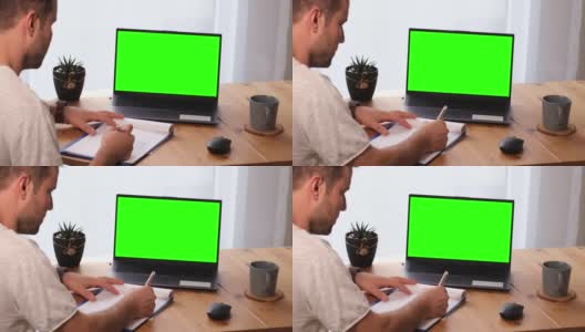 用模拟色度键显示的个人电脑做笔记的人高清在线视频素材下载