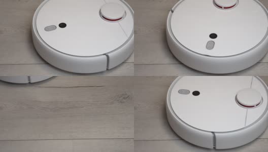 客厅里的机器人吸尘器。现代真空机器人在家里自动清洁。机器人吸尘器清洁木地板高清在线视频素材下载